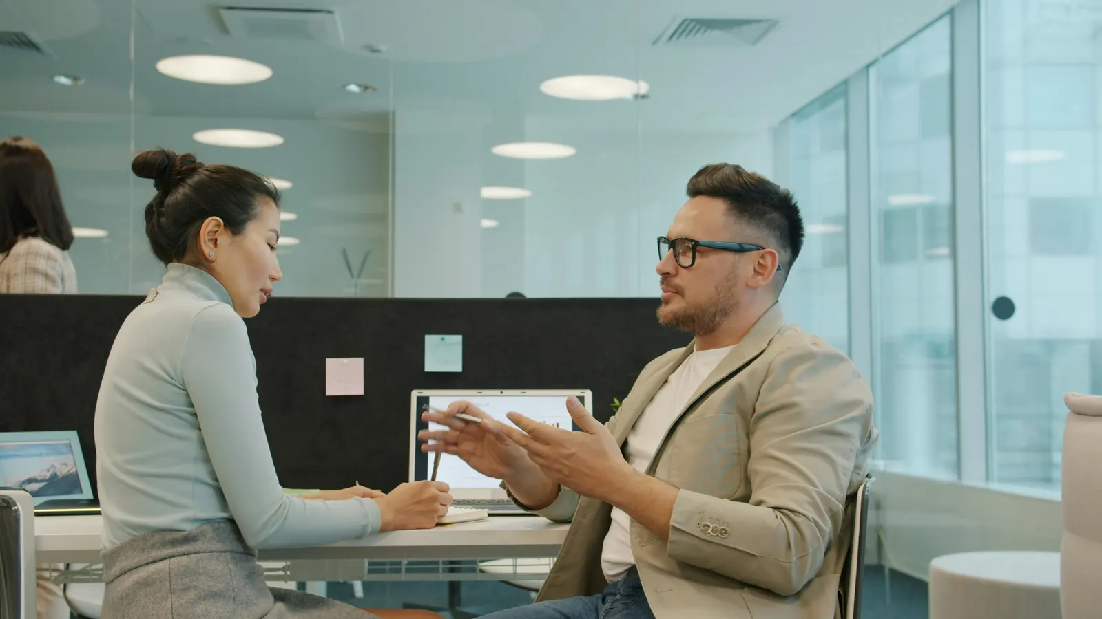 Two consultants talking over a laptop